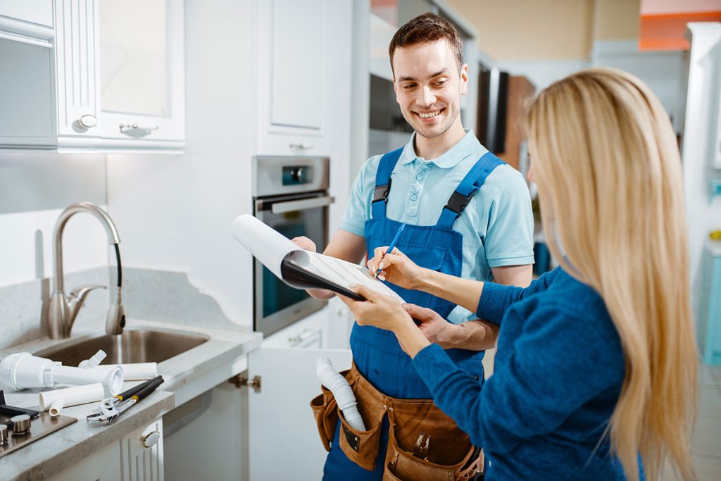 Plumber and Customer Signing Agreement with a Smile
