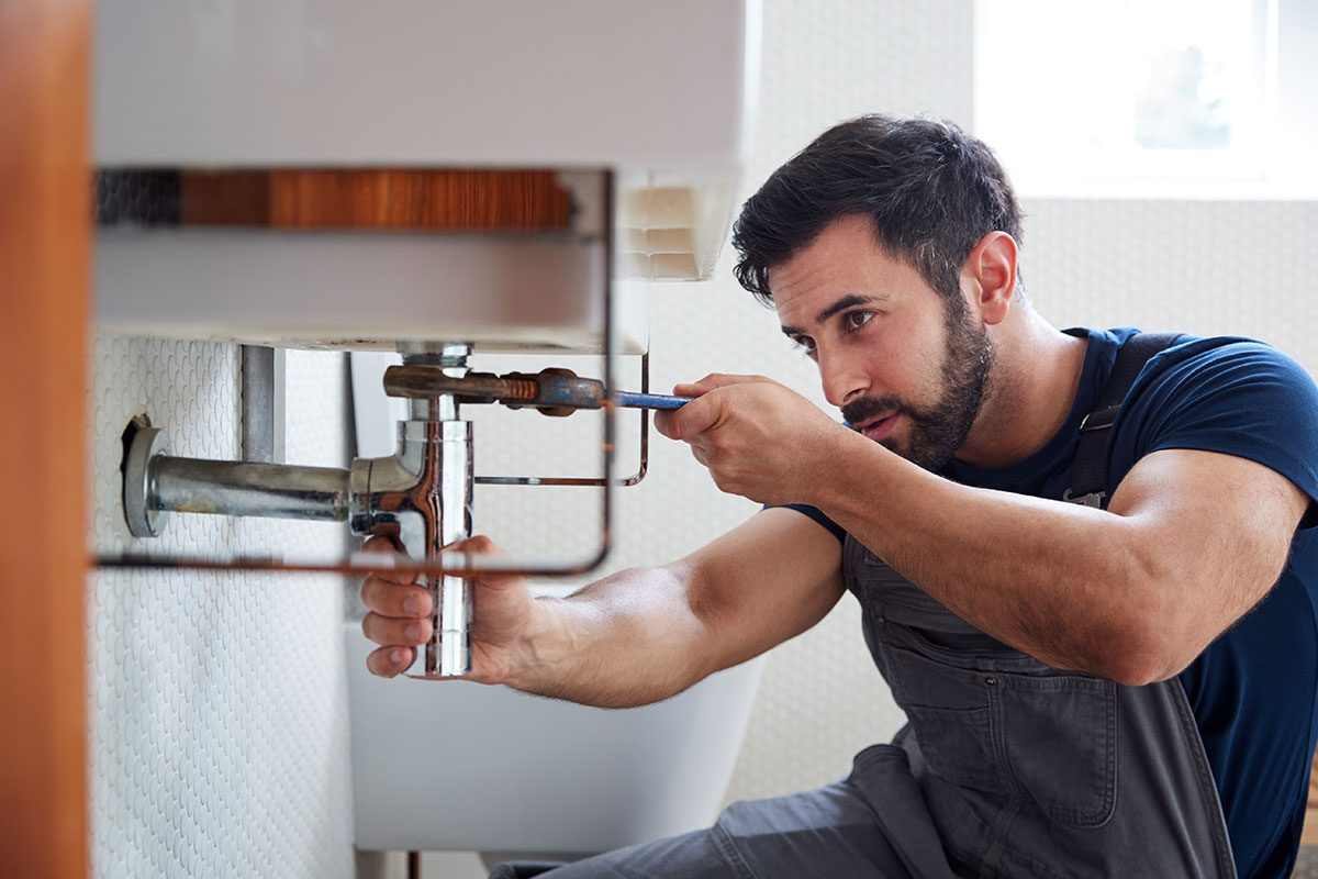Plumber Expert in Edmonton Apartment Stack Flushing Setting Sink Pipe with Wrench