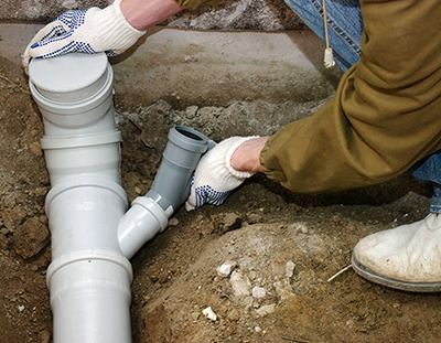 Sewer Repair: Plumber Fixing a Pipe