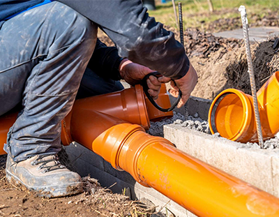 Sewer Repair: Expert Plumber Fixing a Pipe